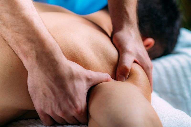 massaging shoulder